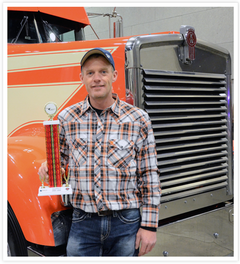 Picture of a guy holding a trophy after winning at the Mid-West Truck and Trailer Show